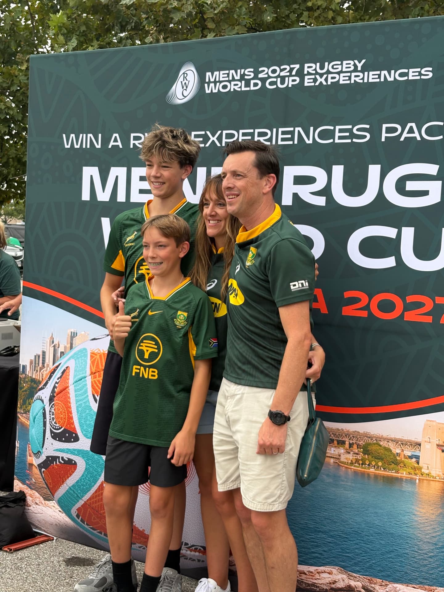 Family wearing Springboks jerseys posing at the World Rugby fan experience