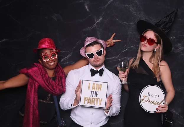 Guests with fun props at a photo booth party