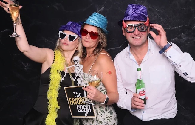 Guests with props at a themed photo booth