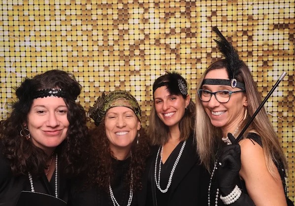 1920s themed photo booth with gold sequin backdrop